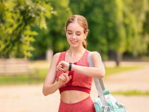 A woman tracking her steps as part of her walking for weight loss plan, monitoring progress with a fitness device.