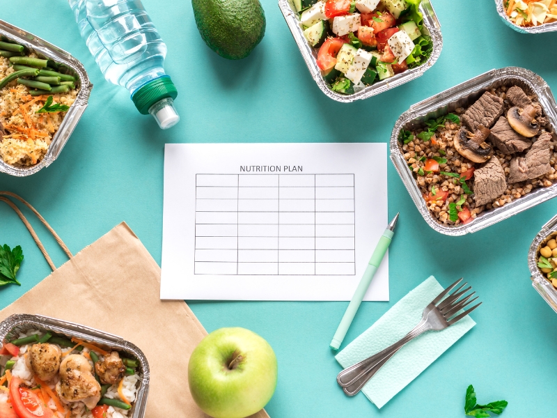 A personalised nutrition plan with healthy meal prep containers and fresh produce.