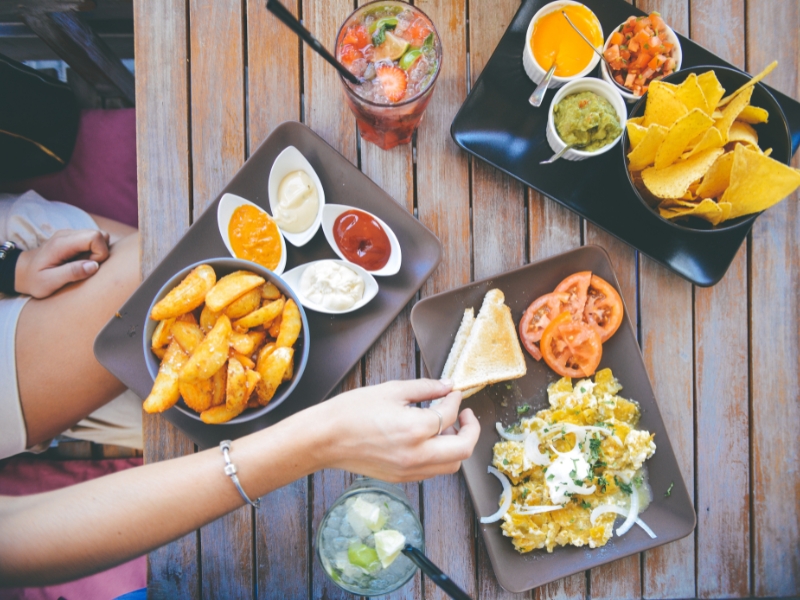 A table full of snacks and dips, showcasing a common trigger to overcome when striving to stop emotional eating.