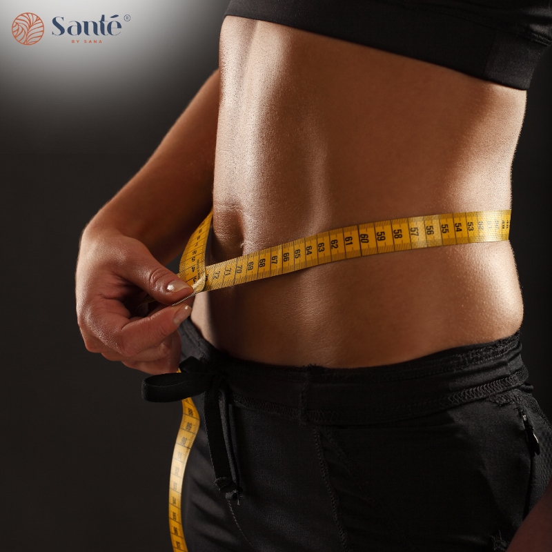 Close-up of a person measuring their waist with a tape measure, symbolising fitness in a Weight Loss Program in Sydney