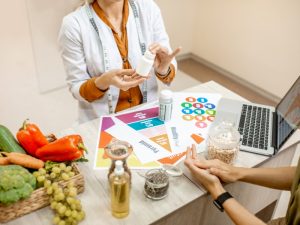 Person consulting a nutritionist about a Gluten-Free Diet Plan, discussing benefits, risks, and personalised meal recommendations.